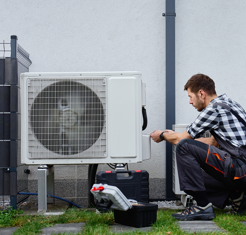 Air conditioning technician repairing a Tulsa AC condenser
