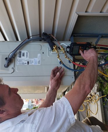 Ductless mini split head being serviced in a Tulsa home